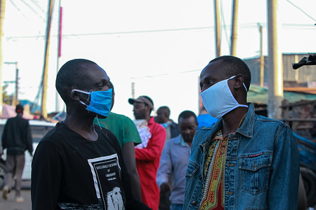Men wearing face masks as a precaution against the spread of coronavirus discuss in Mathare slums.
These items have been on demand after the Government directive on wearing face masks while in public places. On Monday, April 6, Kenyan President Uhuru Kenyatta announced a 21-day cessation of movement in and out of Nairobi and the counties of Kilifi, Kwale, and Mombasa due to the spread of COVID-19 in these regions. This followed a night curfew (7pm to 5am) that had been imposed just days before.