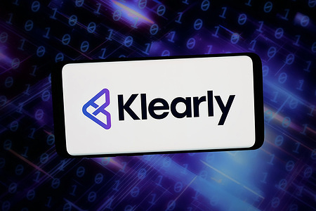 In this photo illustration, the logo of Dutch payment company Klearly B.V. is displayed on a smartphone in front of abstract background on computer screen.