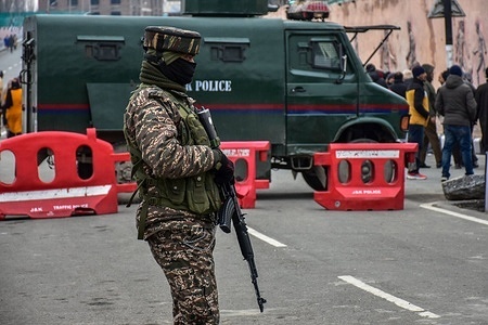 A paramilitary trooper stands alert during India's 77th Republic day celebrations in Srinagar the summer capital of Jammu and Kashmir. The authorities in Kashmir valley organized official functions to mark the 77th Republic Day amidst stepped up security vigil. Checkpoints have been erected at many places and frisking has been intensified.
