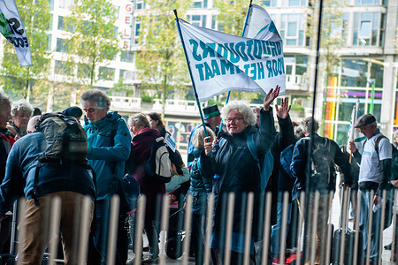 An old woman seen waving a flag as the walkers leaving.
In the run-up to the United Nations COP26 climate conference that will take place in Glasgow, hundreds of climate activists are walking from the North of The Netherlands to Glasgow, to draw attention to the action needed to keep the earth livable for future generations. Led by Marjan Minnesma, a Dutch environmental activist and director of the Urgenda Foundation, the activists departed from the Rotterdam train station to Scotland, where they will keep walking to Glasgow, to attend the climate conference. At the Rotterdam station, climate activists from The 'Grandparents for the Climate' were there to see them off at departure.