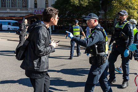 A police officer tells a protester to move on during pro-Palestine and pro-Israel demonstration. Pro-Palestine and pro-Israel protesters came close to a face off in Melbourne, prompting a large Victoria Police response including public order, mounted, and general duties officers. The pro-Palestine rally, drawing an estimated over 1,000 participants, marched through the CBD calling for a ceasefire in Gaza, while fewer than 10 members of the pro-Israel Lions of Zion group held a counter-demonstration. Police formed lines to keep the groups apart, with several tense exchanges and arrests taking place during the event.