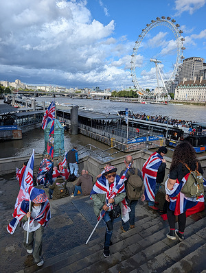 Protesters walk up to Westminster bridge during an anti immigration march. People held Union Flags and the St George Cross during a Tommy Robinson-led Unite The Kingdom march .