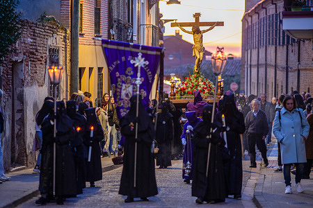 Penitents of the Brotherhood of Nuestro Padre Jesús Nazareno and Patrocinio de San José, support the procession with the image of Jesus on the Cross on their shoulders, during a step of the Via Crucis Processional, which ran through the streets of Sahagún.