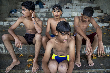 Kashmiri boys seen after swimming in Jhelum River on a hot day in Srinagar, the summer capital of Jammu and Kashmir.