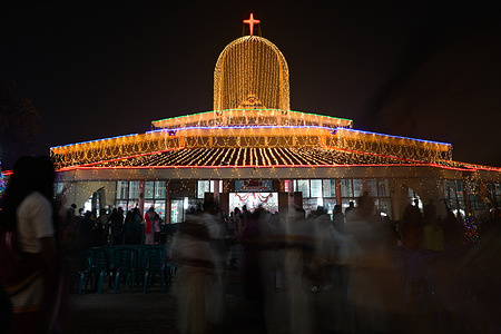 Christian devotees participate in a prayer on Christmas Eve at Tegaon Holy Rosary Church in Dhaka.