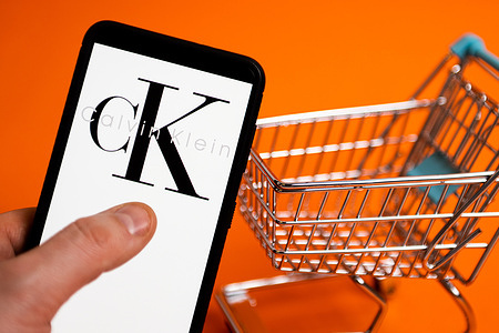 In this photo illustration a Calvin Klein logo seen displayed on a smartphone.