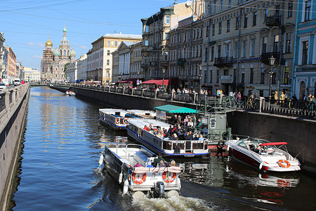 Motorboats take residents and guests of St. Petersburg along the Griboyedov Canal in the center of St. Petersburg.