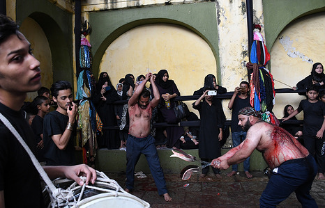 Shiite Muslim men flagellate themselves during Muharram procession in Mumbai. Ashura occurs on the tenth day of Muharram, the first month of Islamic lunar calendar. Shiite Muslims observe it as remembrance of the martyrdom of Imam Hussein, the grandson of Prophet Muhammad.
