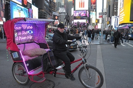 A pedicab driver is seen in Times Square, Manhattan, New York City.