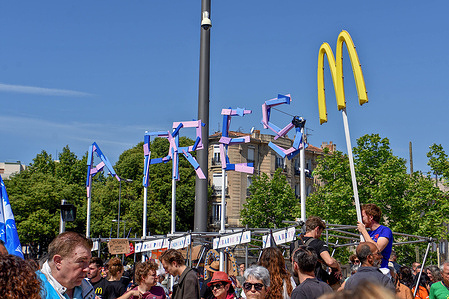 "Apres M" sign seen during the demonstration. "Apres M" activists took part in the annual May Day (Labor Day) demonstration, in Marseille. The "Apres M" is a former McDonald's that became a food bank after staff resisted closing it.