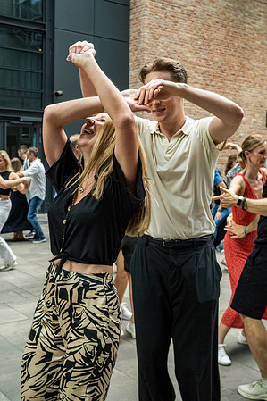Dancers enjoy the free Latin dance party. Norblin Factory Foundation and Dance Studio Salsa Libre invite Varsovian visitors to a unique series of dance meetings. Led by Maja Borkowska and Lukasz Marynowski, the program includes free Salsa and Bachata lessons then an open-air Latin dance party.