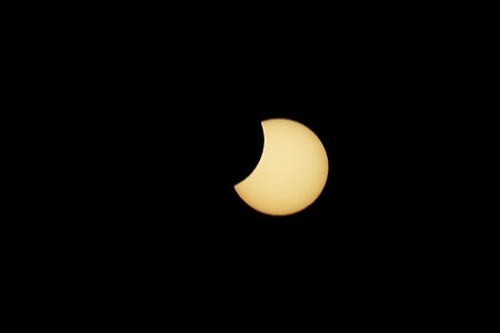 The moon partially covers the sun during the solar eclipse visible from the festival grounds on the opening day of Vodafone Paredes de Coura.