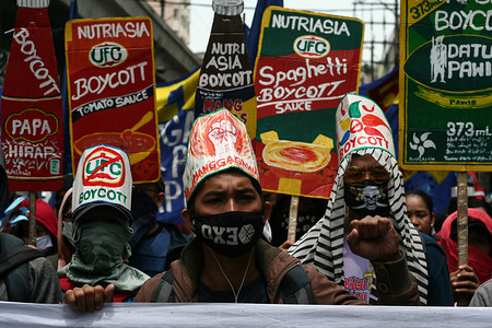 Workers from NutriAsia, a local condiment manufacturer, participate in the Workers March in Manila. Thousands marched through Espana Avenue in Manila as they call for the end of contractualization and the increase of the minimum daily salary to 750 Pesos (about US$ 14). A program was held in Mendiola Bridge, near Malacanang, the presidential palace, after the march.