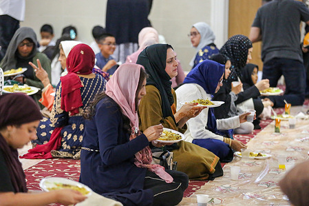 Muslim women seen eating after prayers at East London Mosque.