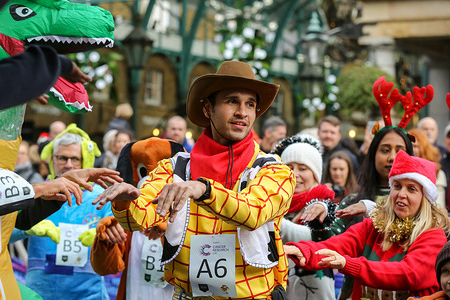 A participant dressed as Toy Story character is seen during the 38th Great Christmas Pudding Race in Covent Garden to raise funds for Cancer Research UK. The race was organised by the Cancer Research Aid Committee (CRAC) in aid of Cancer Research UK.