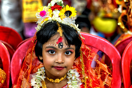 A young girl is seen posing for a photo in the Kumari Puja at the Adyapith temple. Kumari Puja is a Hindu tradition celebrated during the Durga Puja, Basanti Puja, or Navratri, where young virgin girls aged 1 to 16 are worshipped as living embodiments of the goddess. At Adyapith Temple, mothers performed the ritual, which devotees believe bring blessings, protection from future dangers, and strength to the girls to face life's challenges.