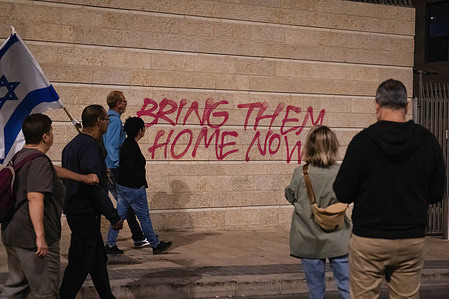 Demonstrators with an Israeli flag march on the street during the demonstration. As the Israeli–Palestinian conflict continues, 13 Israeli hostages have been released on the 24th November from the Gaza strip. About 240 hostages have been held by Hamas in Gaza since the attack on Israel on the 7th October.