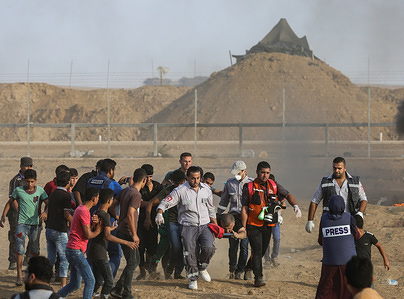 Palestinian paramedics are seen carrying a wounded protester during clashes.
Clashes between Palestinians and the Israeli forces, along the Gaza-Israel border east of Gaza city.