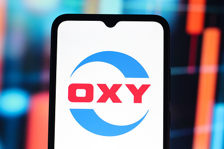 In this photo illustration, the Oxy Chemical (OxyChem) logo is seen displayed on a smartphone screen.