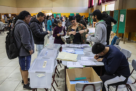 A voter seen casting their vote during the 2025 Chilean presidential elections. People vote during the Chilean presidential elections of 2025.