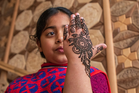 Kashmiri girl shows off her hand decorated with henna ahead of the Muslim festival Eid-Al-Fitr. Eid Al-Fitr is a festival that marks the end of the Muslim holy month of Ramadan.