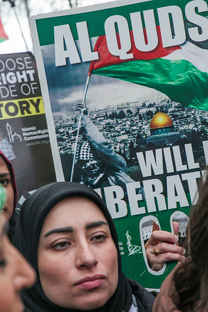 A woman seen carrying a poster to protest Israeli attacks on Iran during al-Quds Day. The annual protest originally planned as a march was held as a static rally after the government banned the march.