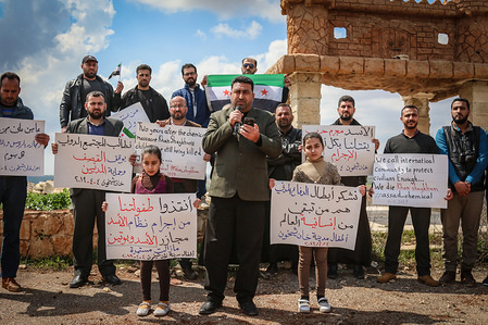 A civilian activist seen speaking on a microphone during the vigil.
Civilian activists organized a vigil in the city of Khan Shekhon to commemorate the second anniversary of the chemical massacre, which killed more than 90 martyrs and hundreds wounded.