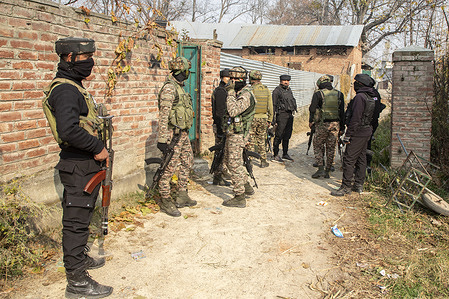 Special Operations Group personnel of Jammu and Kashmir police stand on alert outside a residential home during a cordon and search operation following a deadly car blast in Delhi that killed 13 people and injured dozens.