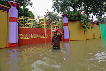 A man seen submerged in flood water half way his body at a residential area in Sunamganj.Flash floods, triggered by heavy rains and upstream water, have inundated Sunamganj town and 11 upazilas of the district, rendering thousands of people marooned.