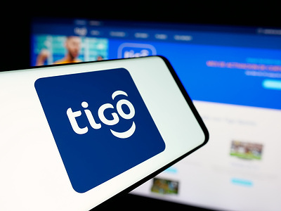 In this photo illustration, a smartphone with the logo of telecommunications company Tigo Bolivia is seen on screen in front of website.
