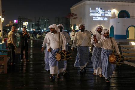 A group dressed in traditional Qatari attire, known as the "Musaharati," roam the streets from midnight until just before dawn, beating their drums to wake people for their pre-dawn meal (Suhur) with religious phrases like "There is no god but God... Suhur, O servants of God." Each neighborhood had its own Musaharati, and the tradition is highly valued in Doha, Qatar, where it remains a cherished symbol of heritage in areas like Katara and the old Doha port.