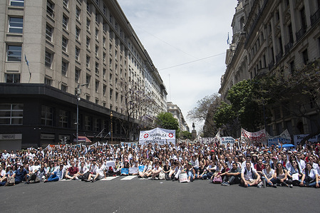 Hundreds of health workers sit in front of the fence that prevents the passage to the Buenos Aires legislature during the public health rally. Argentina health workers held a protest over low wages and poor working conditions due to the crisis of the public health system.
