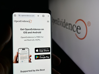 In this photo illustration, a cellphone with the webpage of US medical AI company OpenEvidence Inc. is seen on screen in front of logo.
