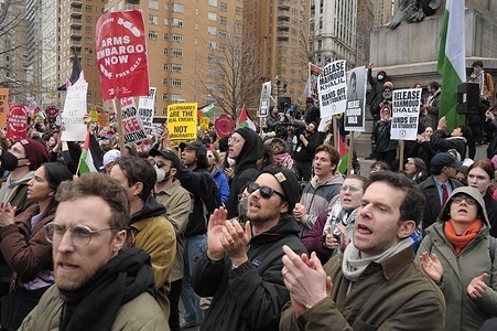 Pro-Palestine demonstrators chant slogans at a rally in Columbus Circle. Demonstrators in Manhattan, New York City condemned the Trump administration for the arrest and planned deportation of Mahmoud Khalil. Khalil, a recent Columbia University graduate, was one of the leading demonstrators during last year’s pro-Palestine protests at the university. Last Saturday, US Immigration and Customs Enforcement, ICE, arrested Khalil who is currently in ICE detention in Louisiana. On Monday, a federal judge temporarily blocked Khalil’s deportation as the deportation is being challenged in court. The Trump administration issued Khalil a notice to appear for an immigration court hearing on March 27 regarding his deportation.