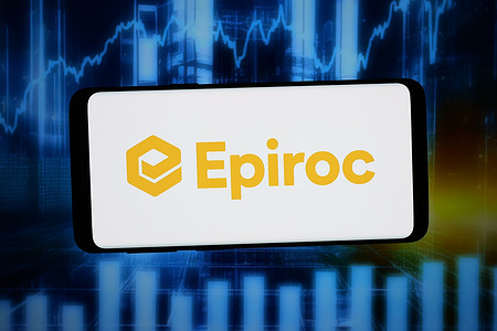 In this photo illustration, the Swedish mining company Epiroc AB logo is seen displayed on a smartphone in front of abstract background on computer screen.