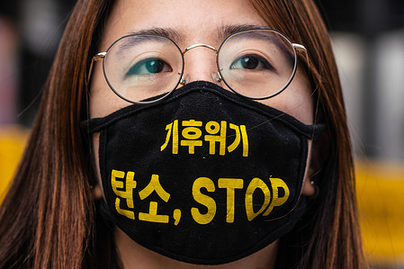 A protester wearing a facemask reading 'Climate Crisis, Stop Carbon' during the climate crisis protest in Seoul.
Climate Strikers gathered in a protest demanding the government to 'Work out Greenhouse Gases Plan 2050' in Seoul.