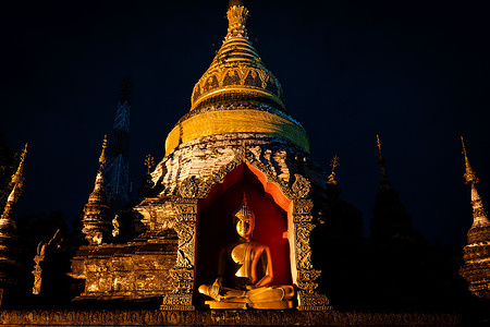 A general view of a Golden Buddha statue on the grounds of Wat Buppharam in Chiang Mai, Thailand. Daily life in Chiang Mai, Thailand as the Thai Government pushes for growth in the international tourism market, recently enacting visa-free entry programs to the Kingdom for international tourists from Russia, China, and India.