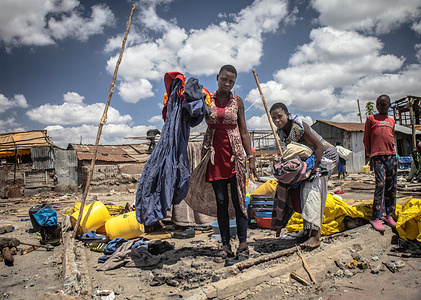 Homeless residents collect their belongings after the demolition of Mukuru Kwa Njenga slums in Nairobi.
Hundreds of residents of Mukuru Kwa Njenga Slums in Nairobi were displaced after their homes were demolished. The demolition was ordered by the local government of Nairobi to make way for the construction of the Nairobi Expressway.