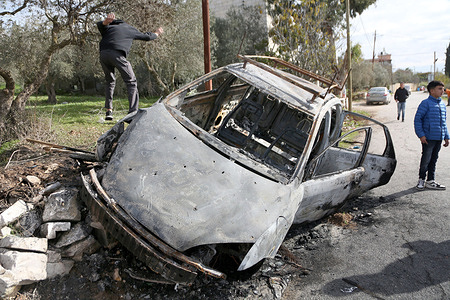 A Palestinian child jumps off from a burnt car after the Israeli forces opened fire on it in the village of Einabus, south of Nablus. The shooting resulted in to the death of 20-year-old Qais Sami Jasser Allan and serious injuries to three others, after the Israeli forces opened fire on a Palestinian car. The Palestinian Red Crescent Society reported that the car overturned and caught fire following an exchange of fire between the villages of Einabus and Huwara. The wounded were taken to Rafidia Surgical Hospital in Nablus. The Israeli military stated that its forces opened fire after the driver allegedly attempted to run over soldiers.