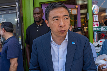 Mayoral candidate Andrew Yang buys a blueberry and ice cream at Max and Mina's during the neighborhood canvassing in New York City.  
Mayoral candidate Andrew Yang meet-and-greet voters in Kew Gardens Hills, Queens.