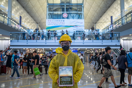 A protester wears a yellow raincoat and a yellow helmet during the protest at the Hong Kong international airport arrival hall.
Thousands of anti government protesters staged a sit in protest at the Hong Kong international airport terminal, the first of three straight days of demonstrations after clashes last week triggered fears that a wider confrontation could erupt in the city.