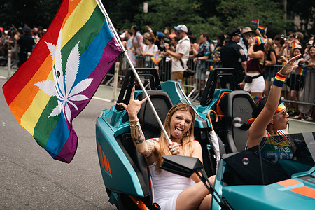 A reveler holds an LGBT flag with marijuana when marching down Fifth Avenue during the annual NYC Pride March. The theme for this year’s NYC pride parade, “Reflect. Empower. Unite.”