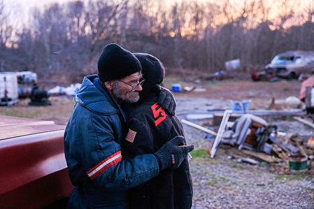 Danny Mensor hugs his girlfriend Shawnee Thompson outside his destroyed home after a tornado that started in Arkansas tore through rural Kentucky. The tornado touched down around 10 p.m. and left a path of destruction for over 200 miles in Kentucky.