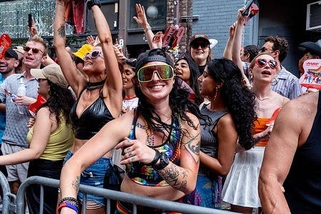 Bystanders enjoy the parade along the route. Hundreds of thousands of spectators and participants come out for the annual NYC Pride March celebrating the LGBTQ community in NYC.