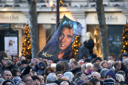 Johnny Hallyday’s fans seen holding a large portrait of their favorite singer during Johnny Hallyday’s funerals at Eglise de la Madeleine.