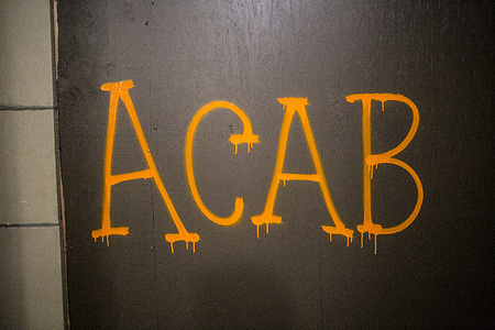 "ACAB" (All Cops Are Bastards) is spray painted on a boarded door in downtown Portland during the march.
For the second night since the air pollution from the Oregon Wildfires has cleared in Portland, protesters have taken to the streets to continue the protest movement that began after the killing of George Floyd.