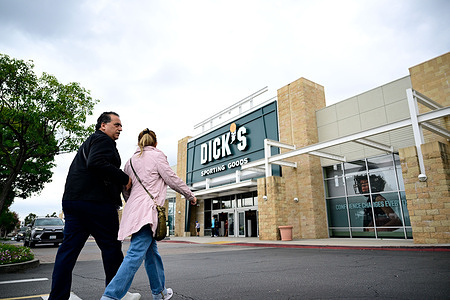 A man and a woman walk into a Dick’s Sporting Goods store in Pasadena, ahead of the company’s fiscal first-quarter 2026 earnings release. Analysts expect the retailer to report earnings of about $2.91 per share on roughly $5.07 billion in revenue as investors monitor consumer spending and demand ahead of the summer retail season.