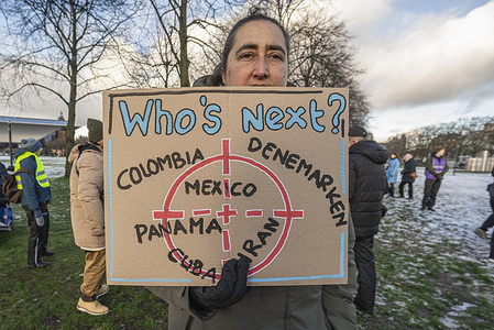 A protester holds a placard expressing her opinion during the anti-Trumps demonstration outside the U.S. Consulate. A few hundred ant-Trump protesters demonstrated outside the U.S. Consulate by the Museumplein in Amsterdam, against the US attack on Venezuela. The protest was organized by the People for Pease and the Anti-Fascist Former Resistance Fighters of the Netherlands (AFVN), NCPN’ (New Communist Party of the Netherlands) and the socialist youth group ROOD.