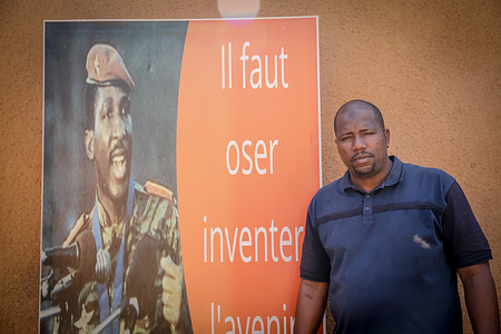 Abdoulaye Seydou, human rights defender and M62 coordinator, stands beside a poster of Thomas Sankara, who he said is one of his idols. The day after this photo was taken Seydou was arrested. M62 has been campaigning to have the French military ousted from Niger, following in the footsteps of neighbouring Burkina Faso and Mali.