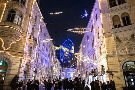 People walk through the streets decorated with Christmas lights during festive season.
Festive season in Ljubljana begins under restrictions amid high numbers of COVID-19 infections.